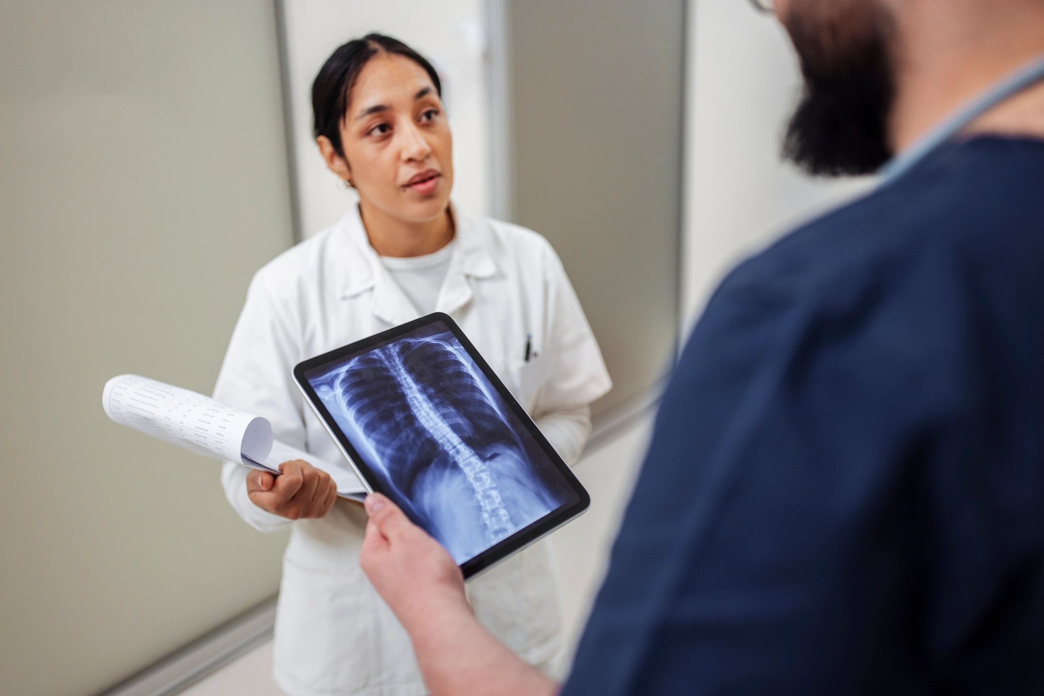 Medical professionals reviewing digital imaging on a tablet