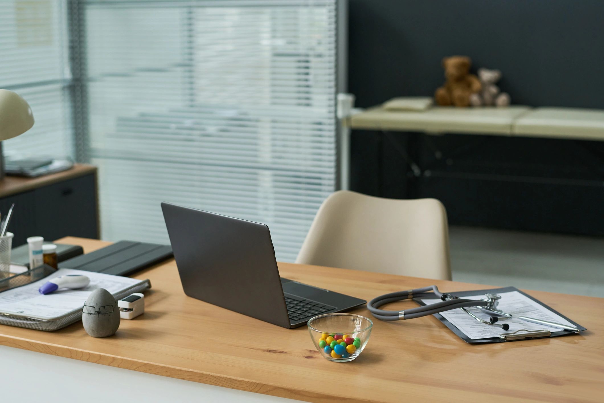 Healthcare workspace with laptop and consultation tools